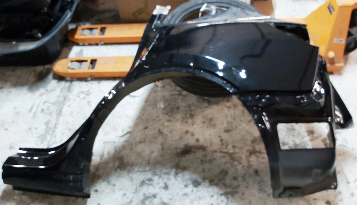 3 Quarter rear left fender with body fragments PBSB Tesla model Y 1549230-S0-A
